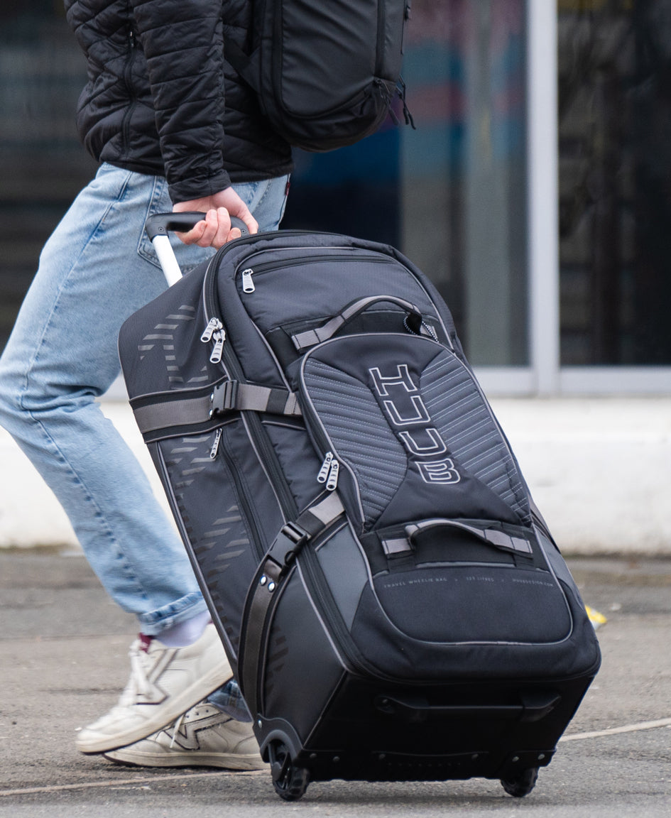 HUUB Travel Wheelie Bag – 95L, hard wheels, retractable handle, internal pockets, black pro athlete luggage